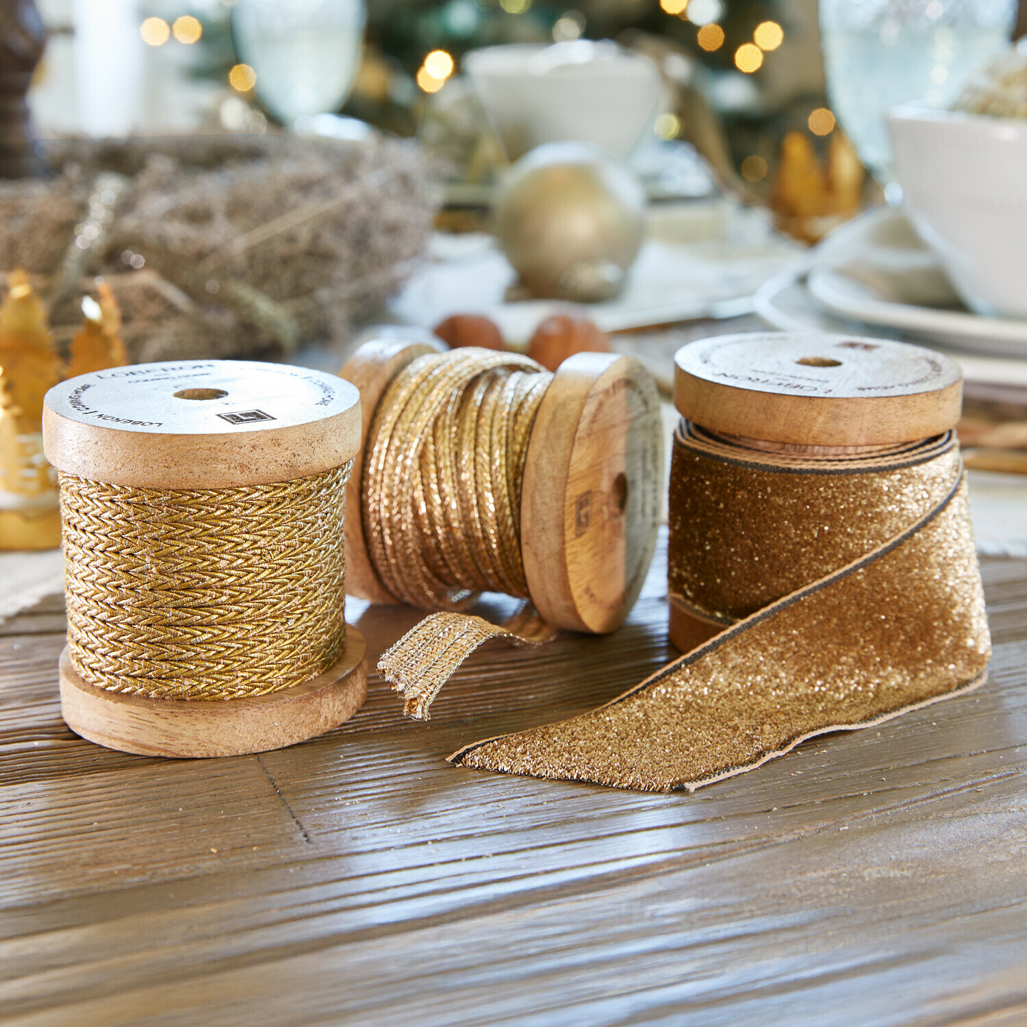 Band 3er Set Tamsworth Drei goldene Dekobänder auf Holzspulen auf festlich dekoriertem Tisch mit Weihnachtsdeko