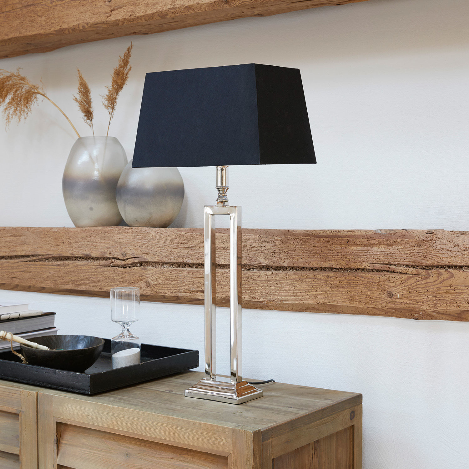 Tischlampe Kinshaa Elegante Tischlampe mit Metallfuß und schwarzem Lampenschirm auf hellem Holzsideboard