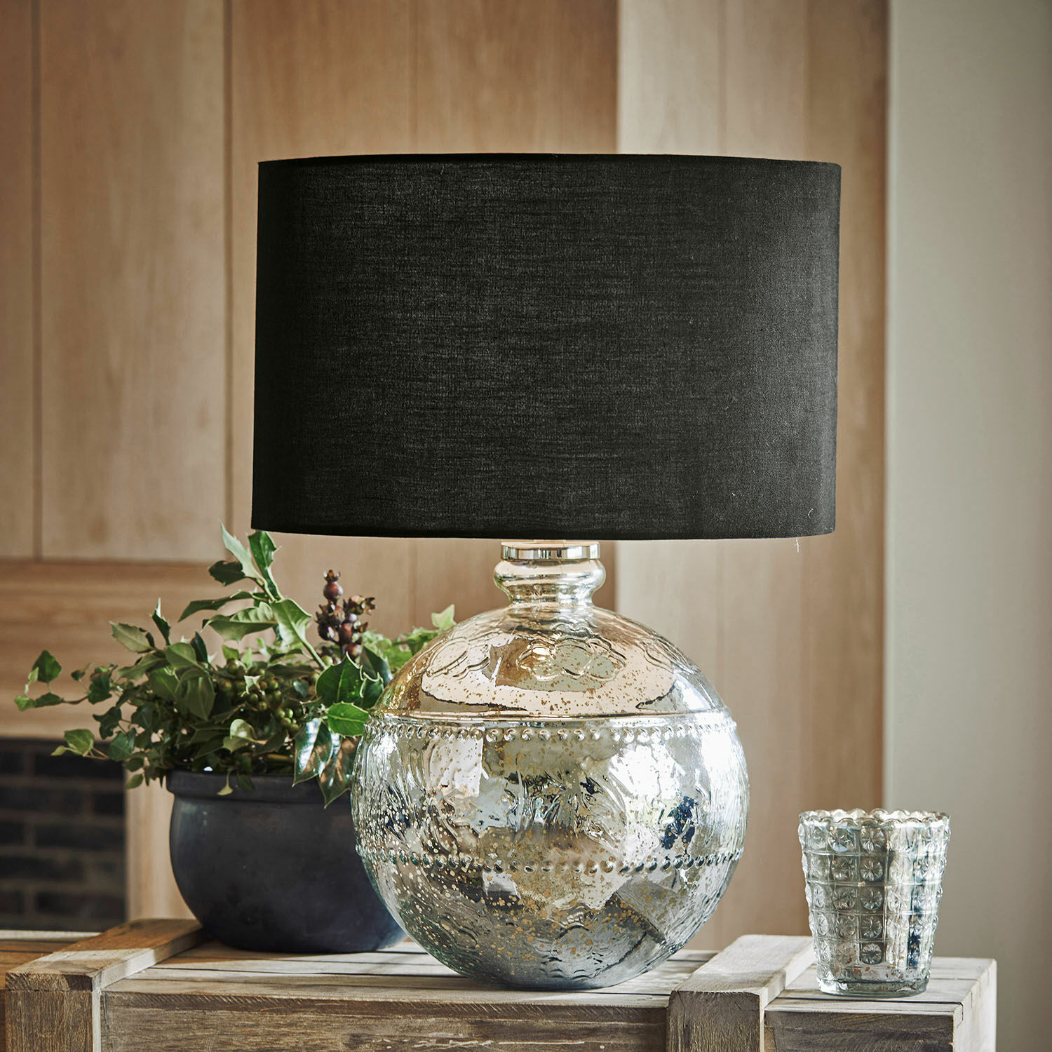 Tischlampe Voyer Dekorative Tischlampe mit silbernem Glasfuß und schwarzem Lampenschirm auf Holztisch