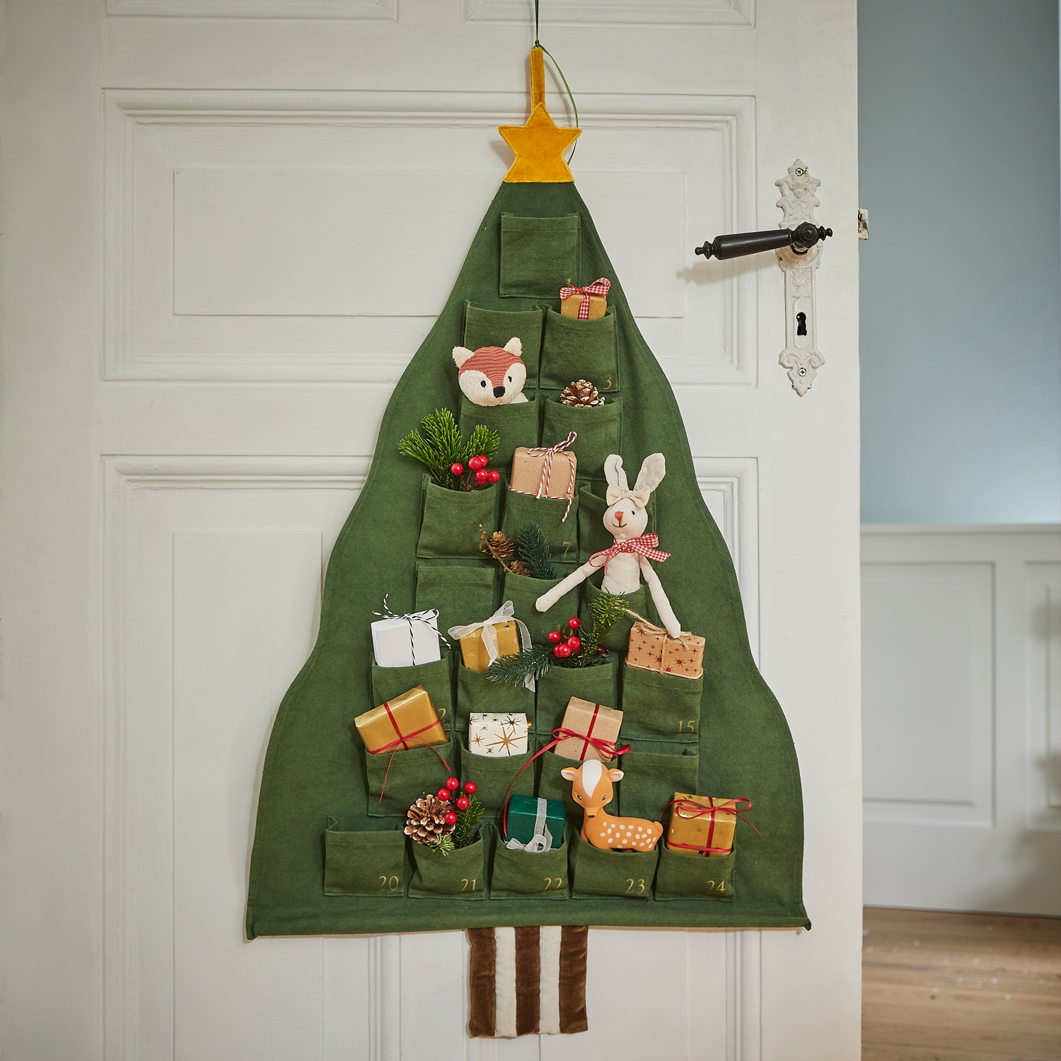 Grüner Adventskalender aus Stoff in Tannenbaumform mit Taschen und Weihnachtsdekorationen