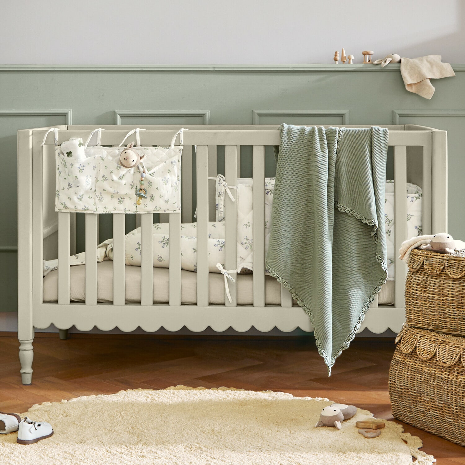 Babybett Leily Beige Kinderbett aus Holz mit grünem Decken und floral gemusterter Bettwäsche in gemütlichem Kinderzimmer