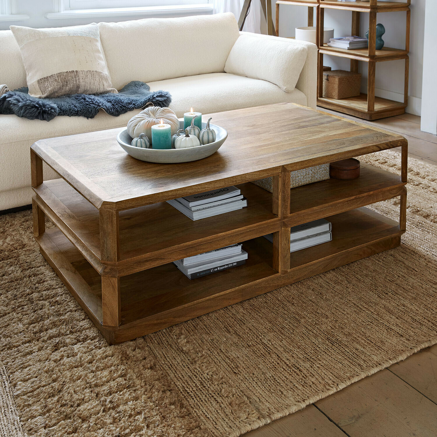 Couchtisch Inverly Holz-Couchtisch in Naturfarbe mit Ablageflächen auf beigem Teppich im Wohnzimmer