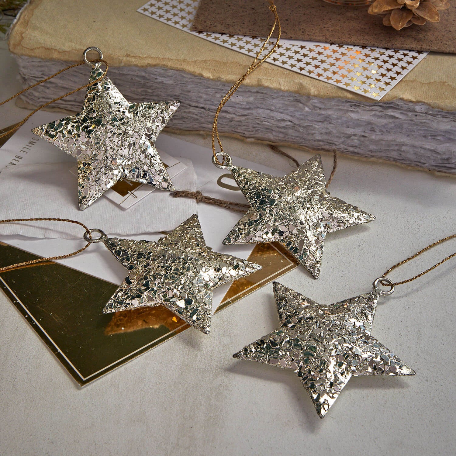 Set aus vier silbernen, strukturierten Sternen zum Aufhängen, festliche Weihnachtsdekoration