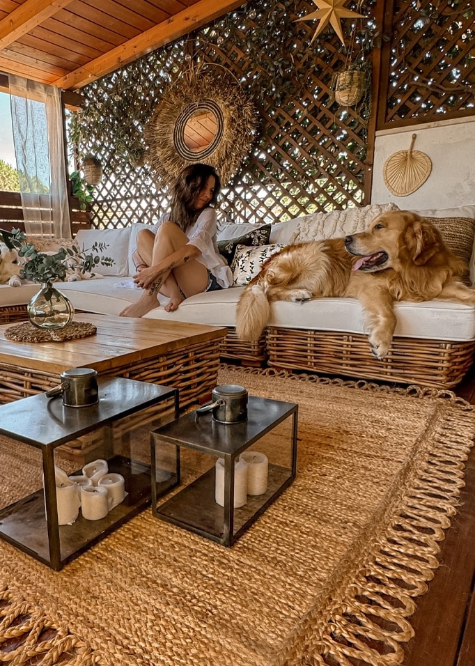 Gemütliches Wohnzimmer mit Rattansofa, Naturteppich und Dekorationen aus Seegras