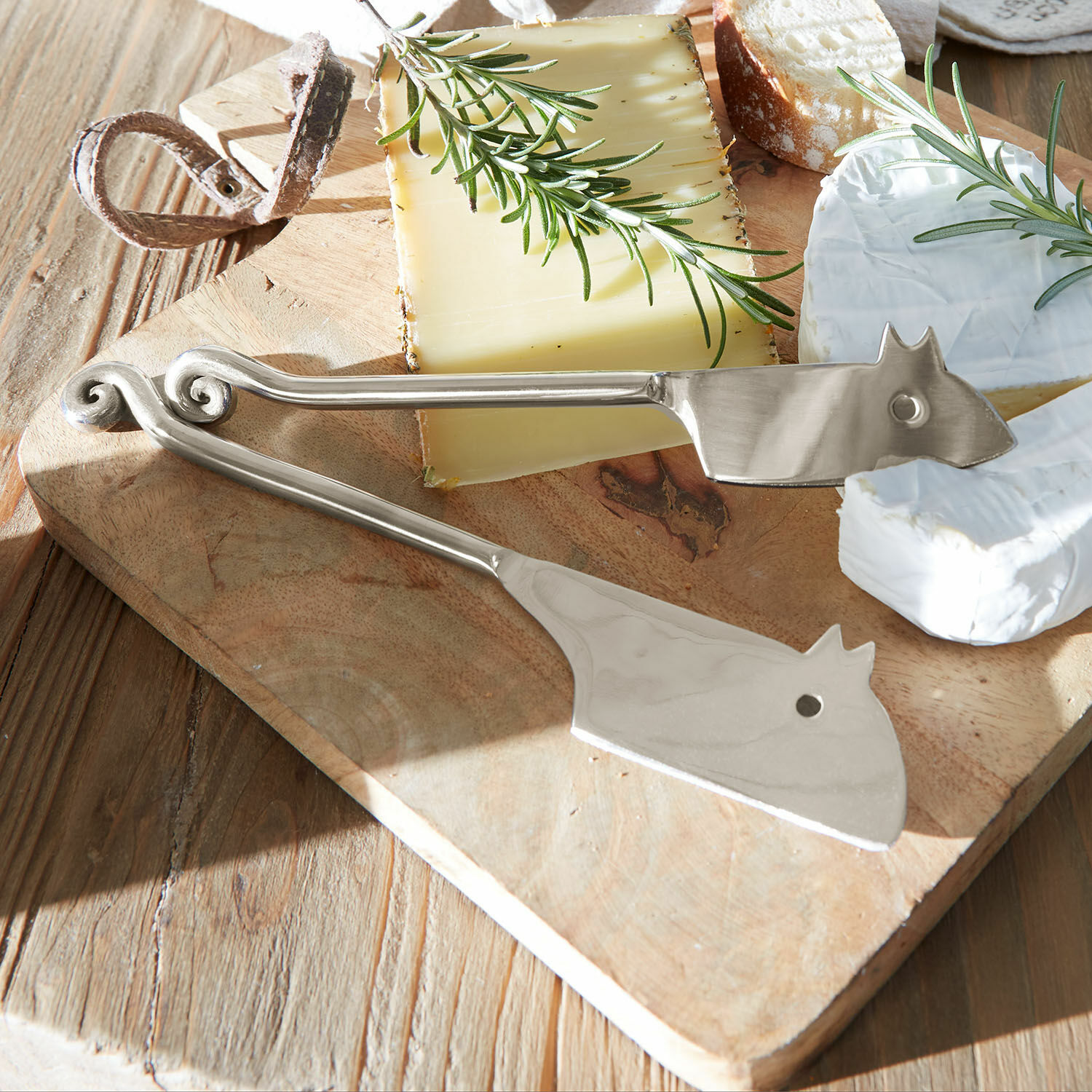 Käsemesser 2er Set Hadley Silberne Käsezange aus Edelstahl auf Holzbrett mit Käse und Rosmarin dekoriert