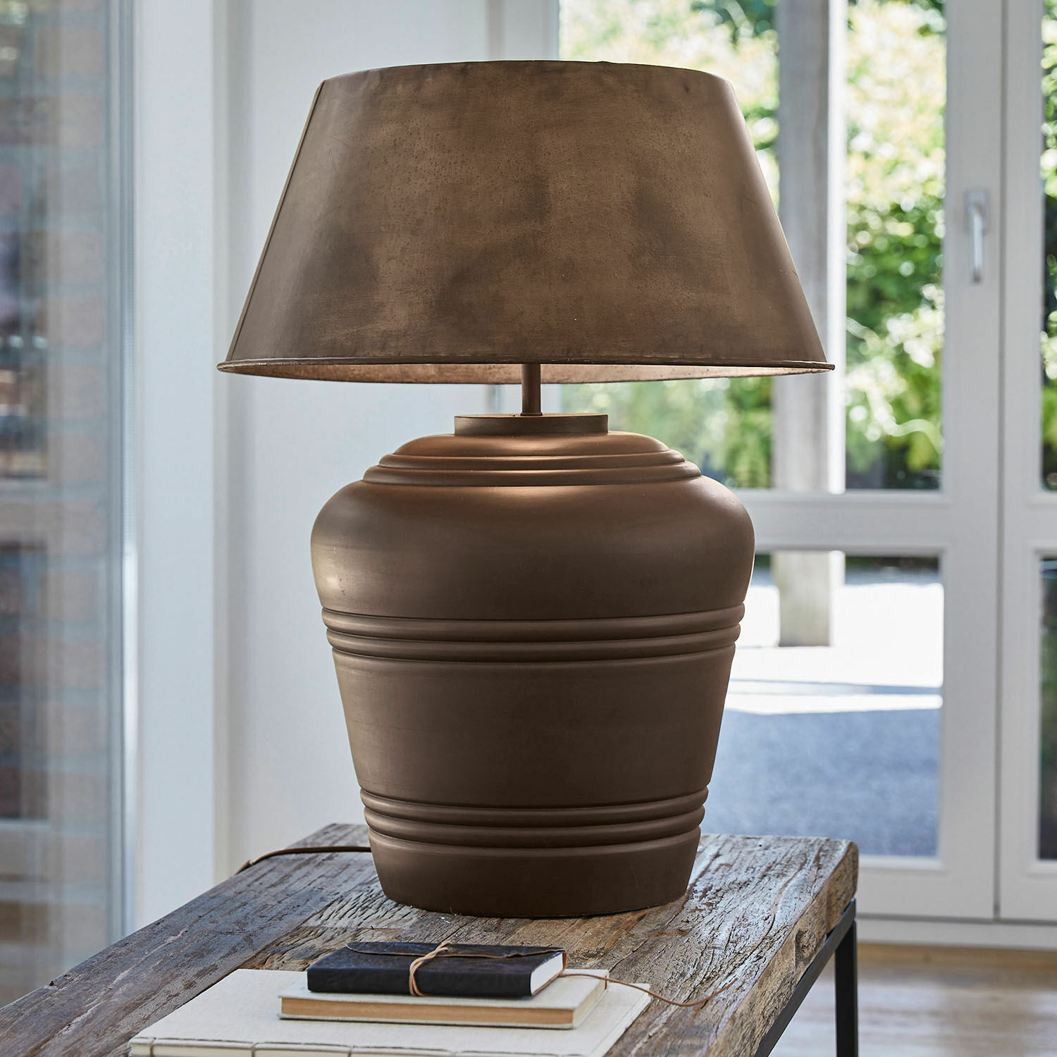 Tischlampe Morice Braune Keramik-Tischlampe mit Lampenschirm auf rustikalem Holztisch in hellem Raum