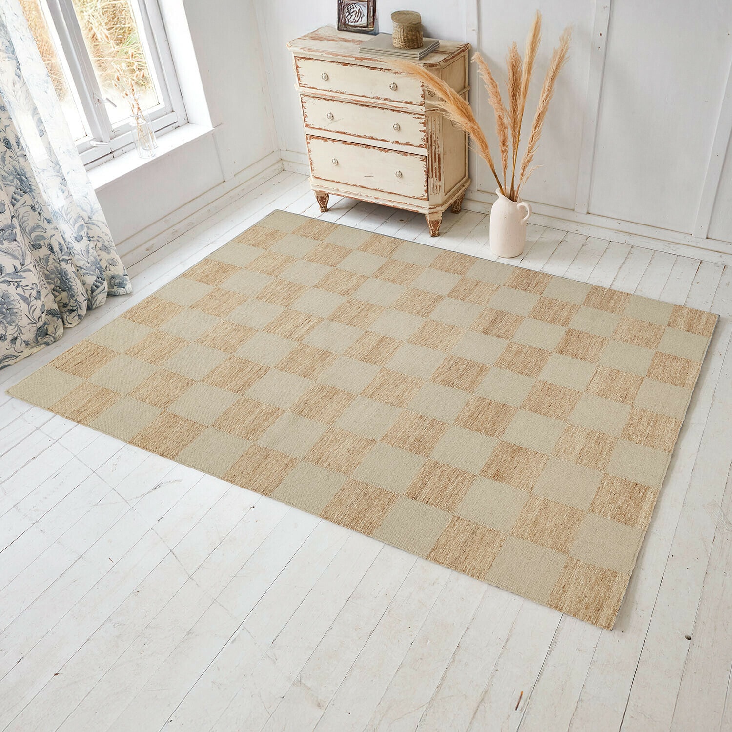 Teppich Nexari Beiger Teppich mit Karomuster aus Naturmaterial auf hellem Holzboden in hellem Raum