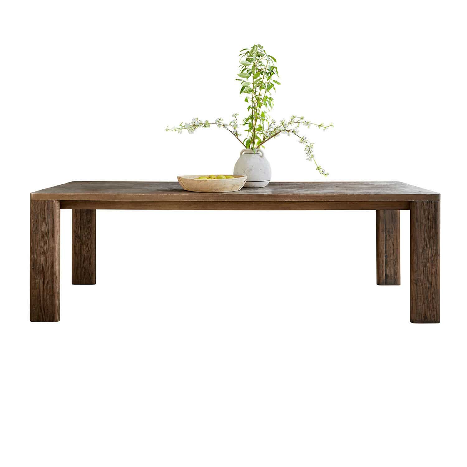 Dunkler Holztisch mit rechteckiger Platte, dekoriert mit Keramikvase mit grünen Zweigen und Obstschale