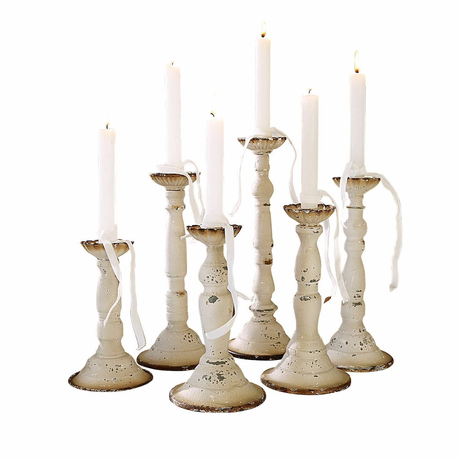 Kerzenhalter 6er Set Rivondelle Set aus sieben weißen Metall-Kerzenhaltern mit antikem Finish und weißen brennenden Kerzen
