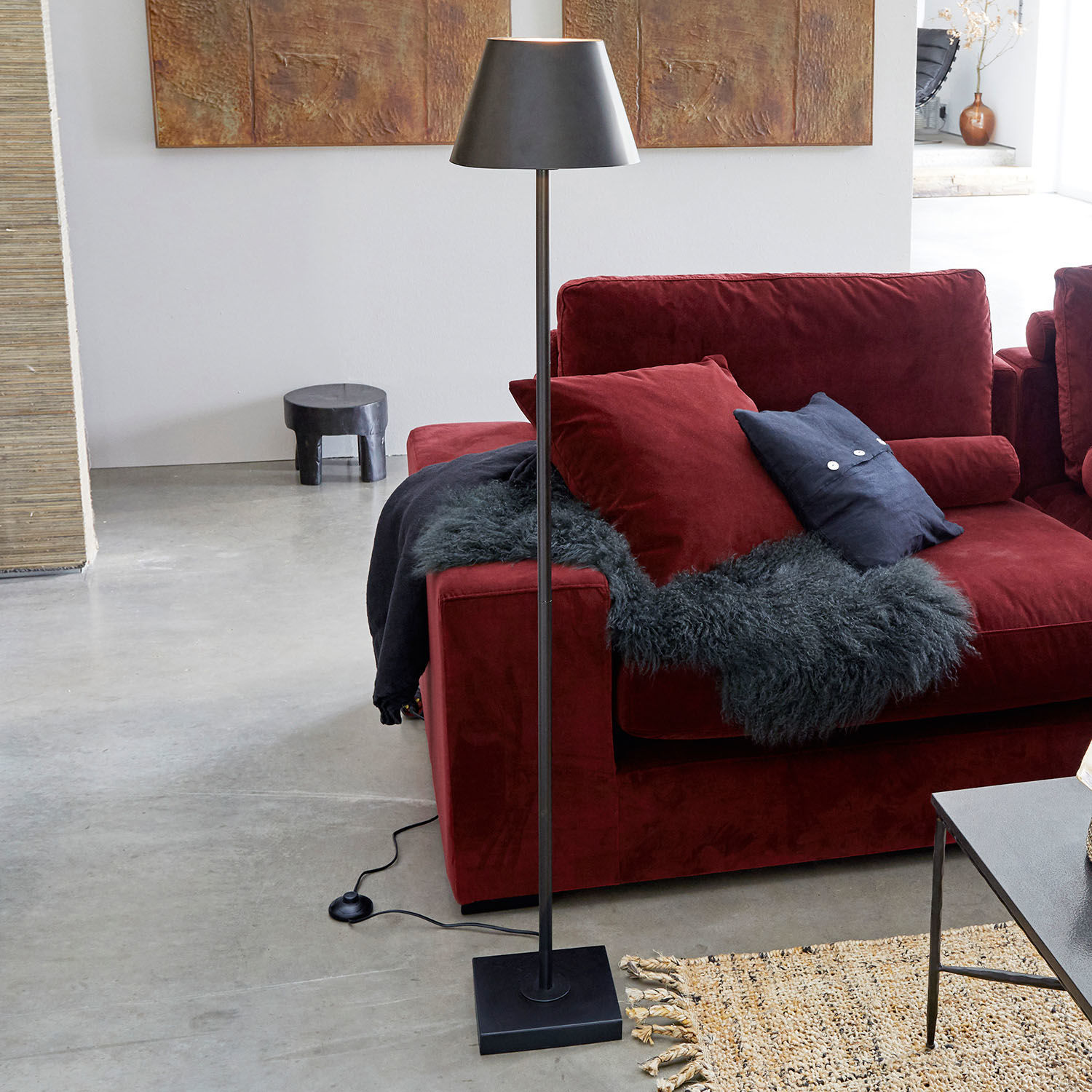 Stehlampe Marjan Schwarze Stehlampe aus Metall mit Lampenschirm neben rotem Sofa und Teppich im modernen Wohnzimmer
