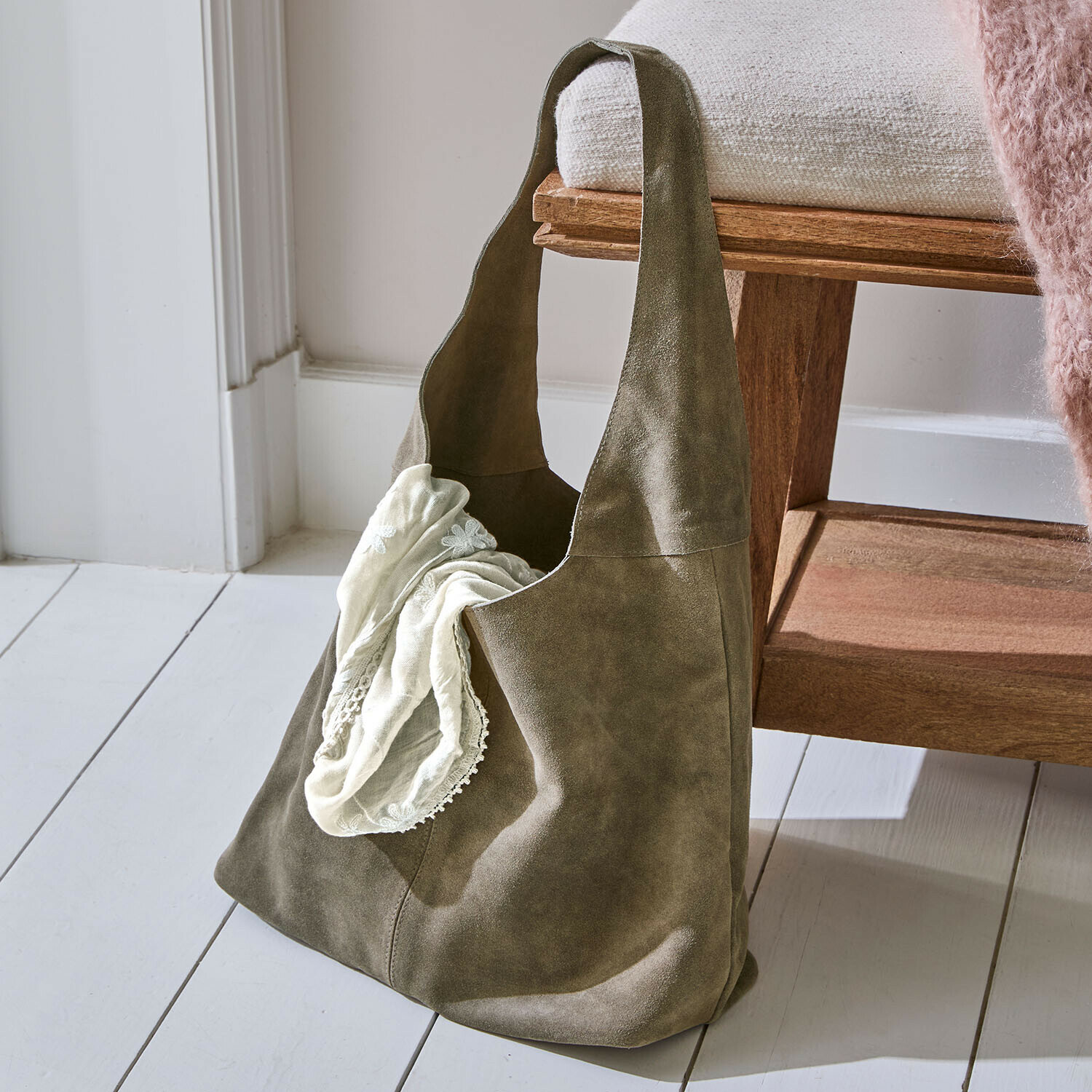 Grüne Tasche aus weichem Wildleder mit cremefarbenem Tuch, praktisches Accessoire für den Alltag