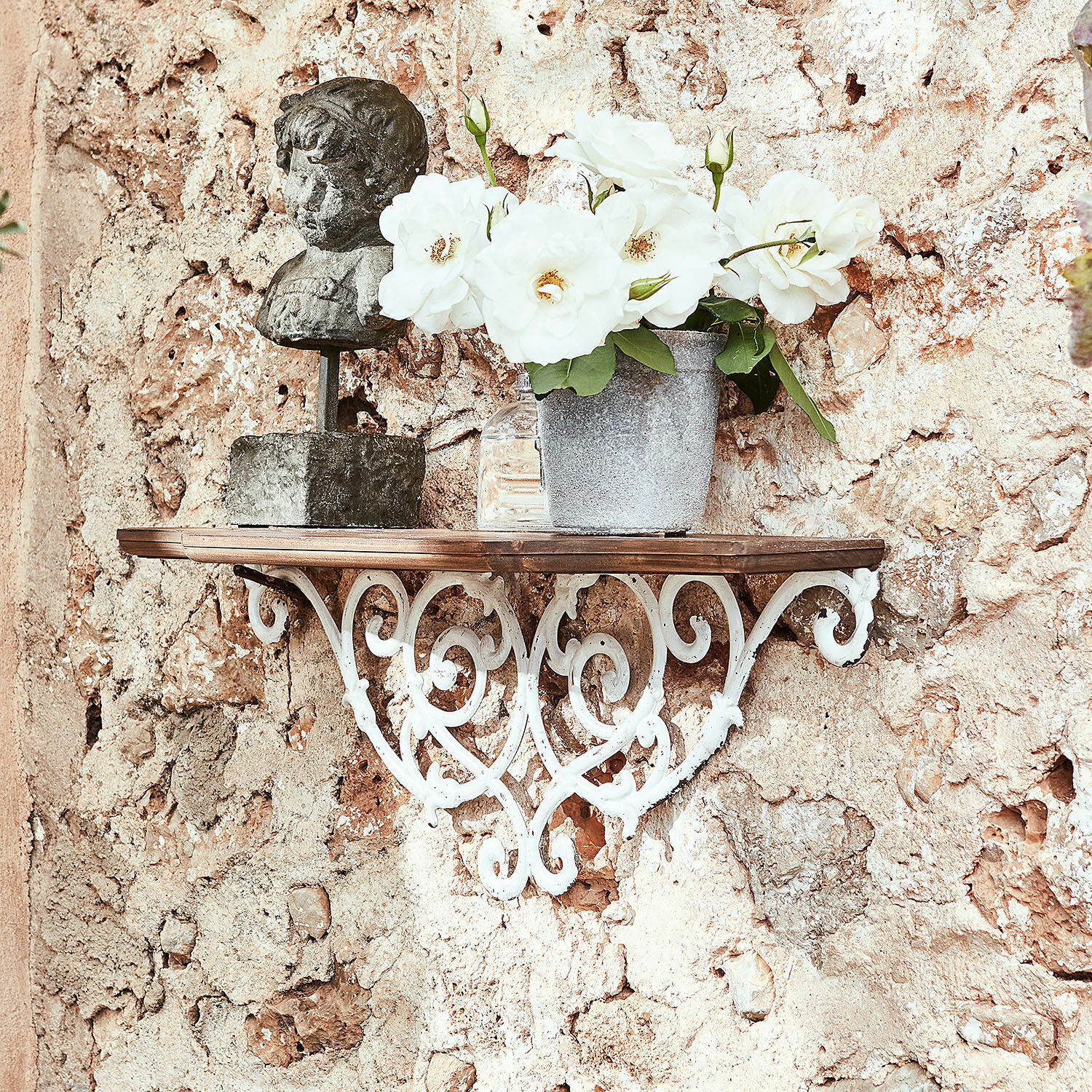 Rustikales Wandregal aus Schmiedeeisen und Holz mit dekorativer Büste und weißen Blumen
