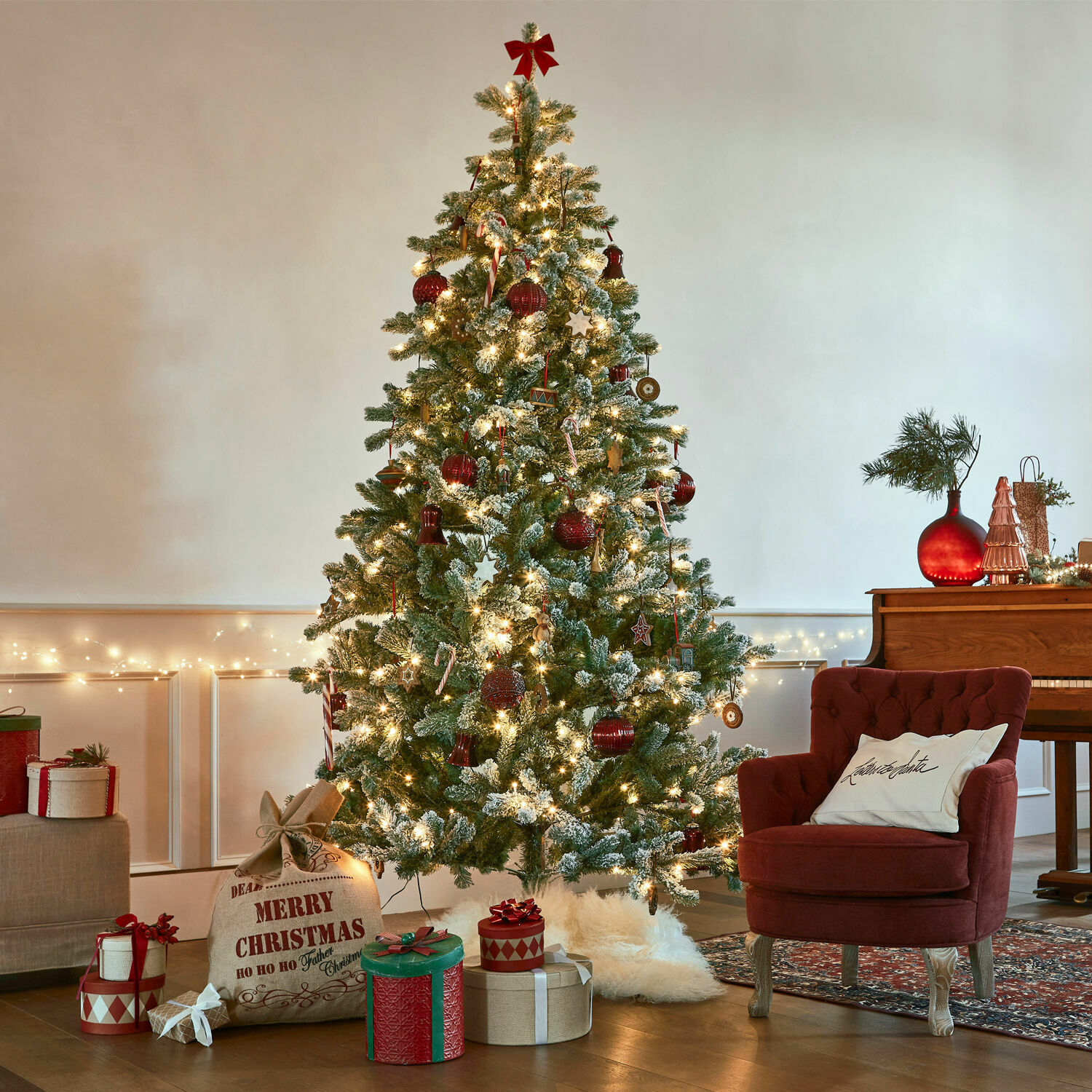 Weihnachtsbaum Mannier Künstlicher, schneebedeckter Weihnachtsbaum mit roten Kugeln und Lichterketten in gemütlichem Wohnzimmer