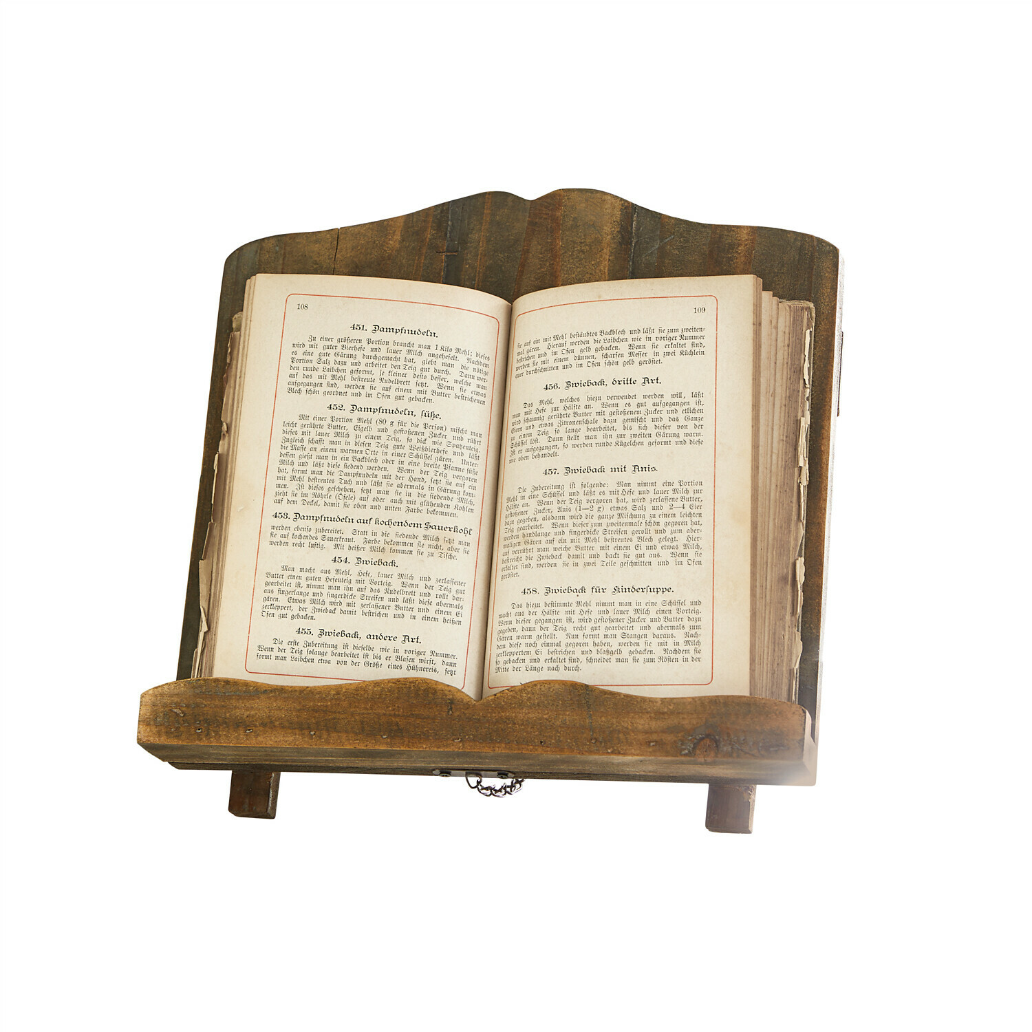 Buchstütze Mags Brauner Holzbuchständer mit aufgeschlagenem altem Kochbuch darauf