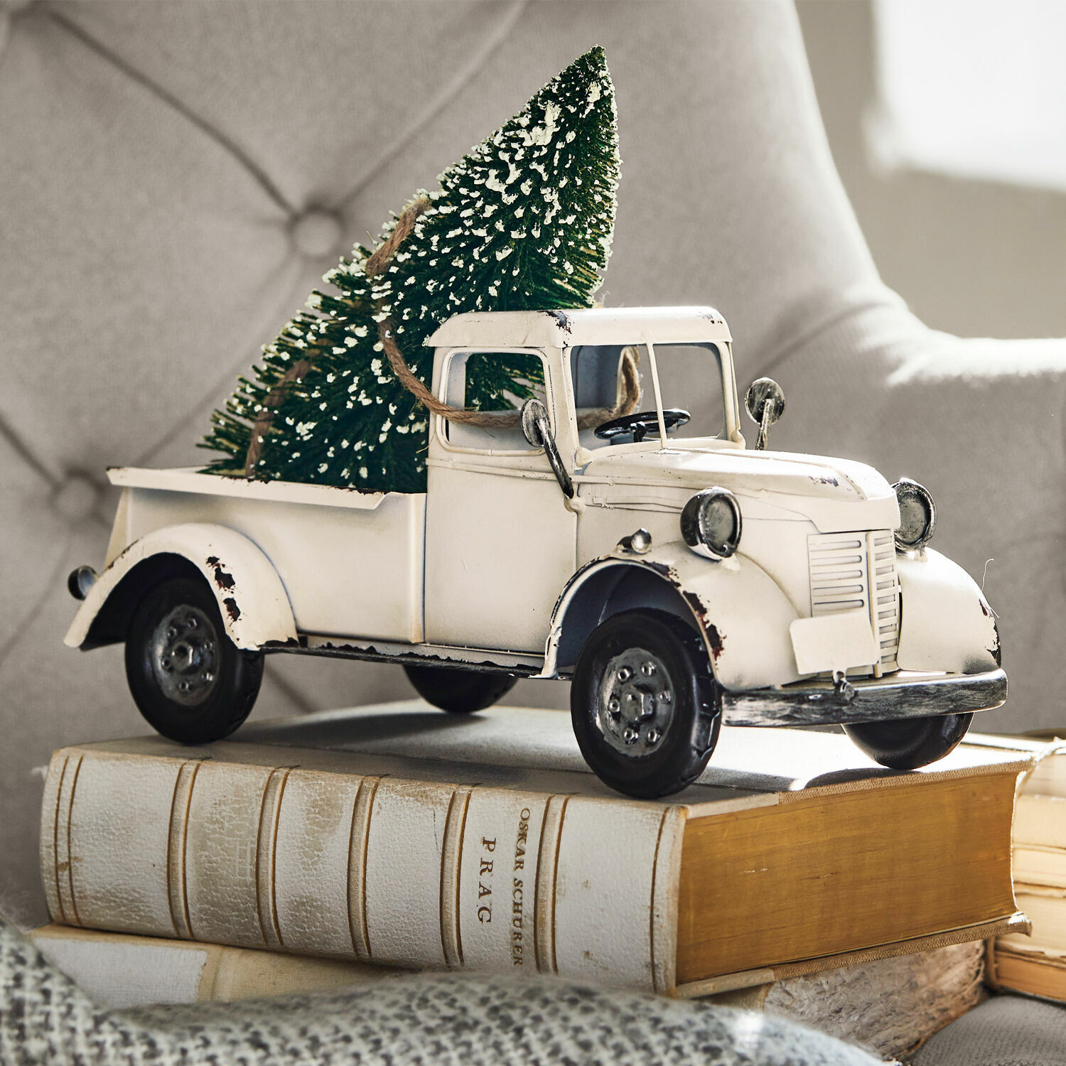 Deko-Auto Formis Weißes Metallmodell eines alten Lastwagens mit grünem Tannenbaum auf Büchern, Weihnachtsdeko